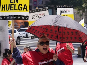 caption: Striking hotel workers rally outside the InterContinental Los Angeles Downtown Hotel on Tuesday, July 4, 2023. (AP Photo/Damian Dovarganes)
