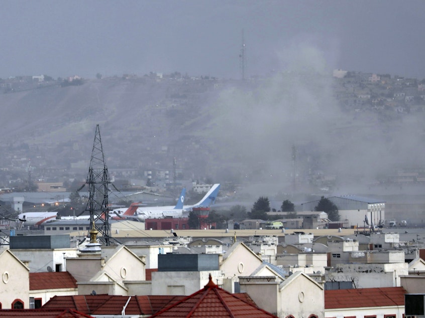caption: Smoke rises from a deadly explosion outside the airport in Kabul, Afghanistan, Thursday, Aug. 26, 2021. Two suicide bombers targeted crowds massing near the Kabul airport, in the waning days of a massive airlift that has drawn thousands of people seeking to flee the Taliban takeover.