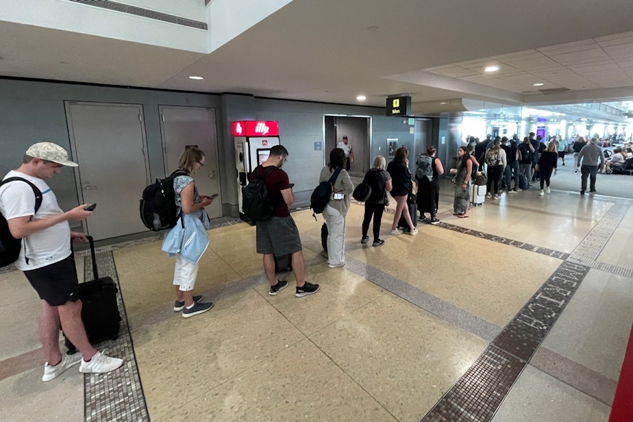 caption: Stranded Delta passengers wait in line for access to a Delta help desk in Denver International Airport on July 22, 2024.