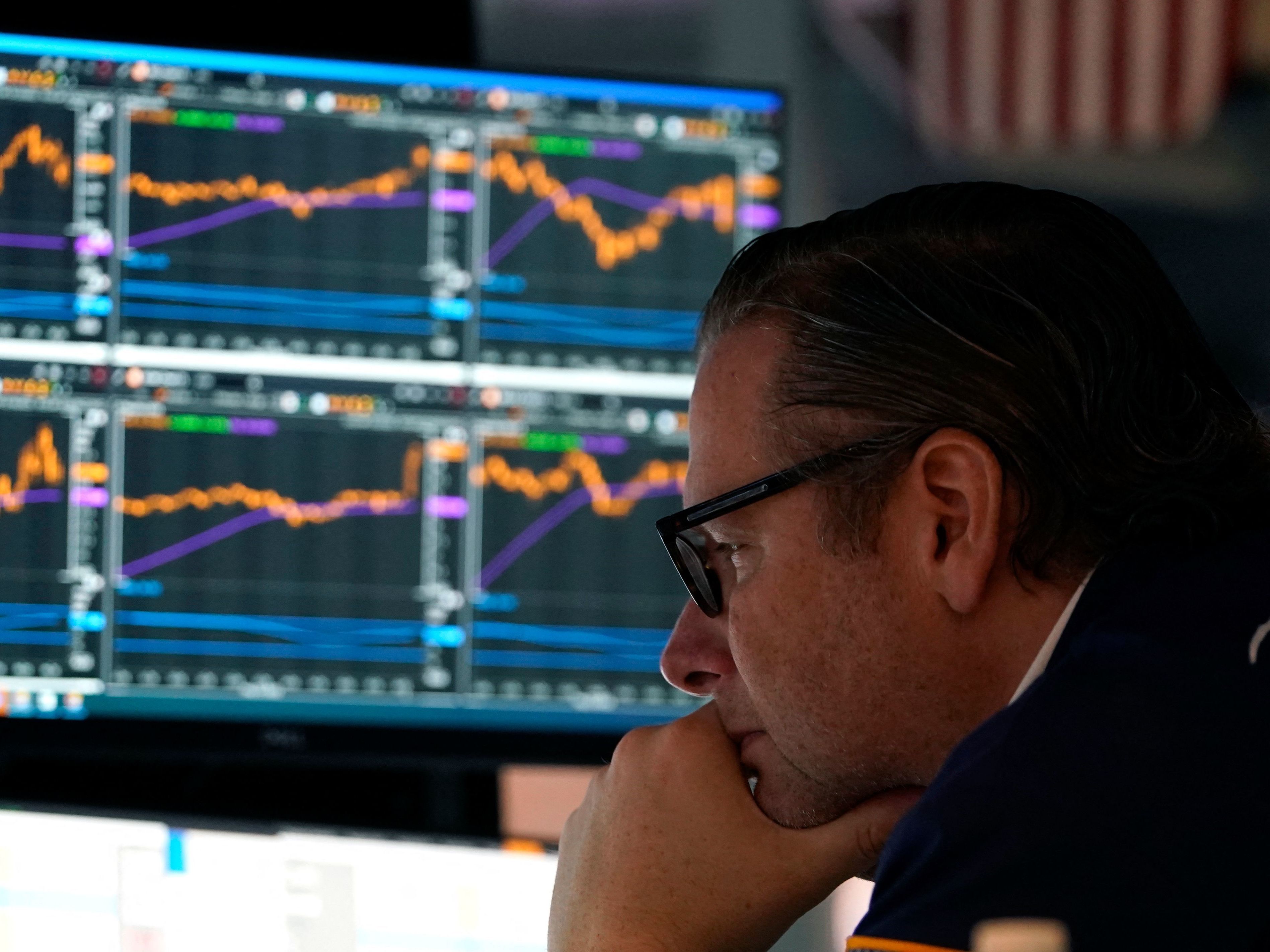caption: Traders work on the floor during the opening bell of the New York Stock Exchange in New York City on May 16. Stocks slumped on Wednesday as earnings from major retailers such as Target reinforced concerns about the U.S. economy.