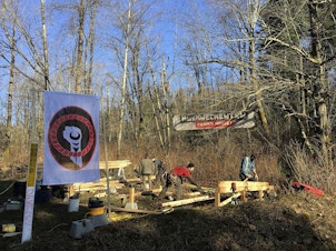 caption: FILE: Anti-pipeline activists build a so-called 'Watch House' near Kinder Morgan's tank farm in Burnaby, British Columbia, Canada, Saturday, March 10, 2018.