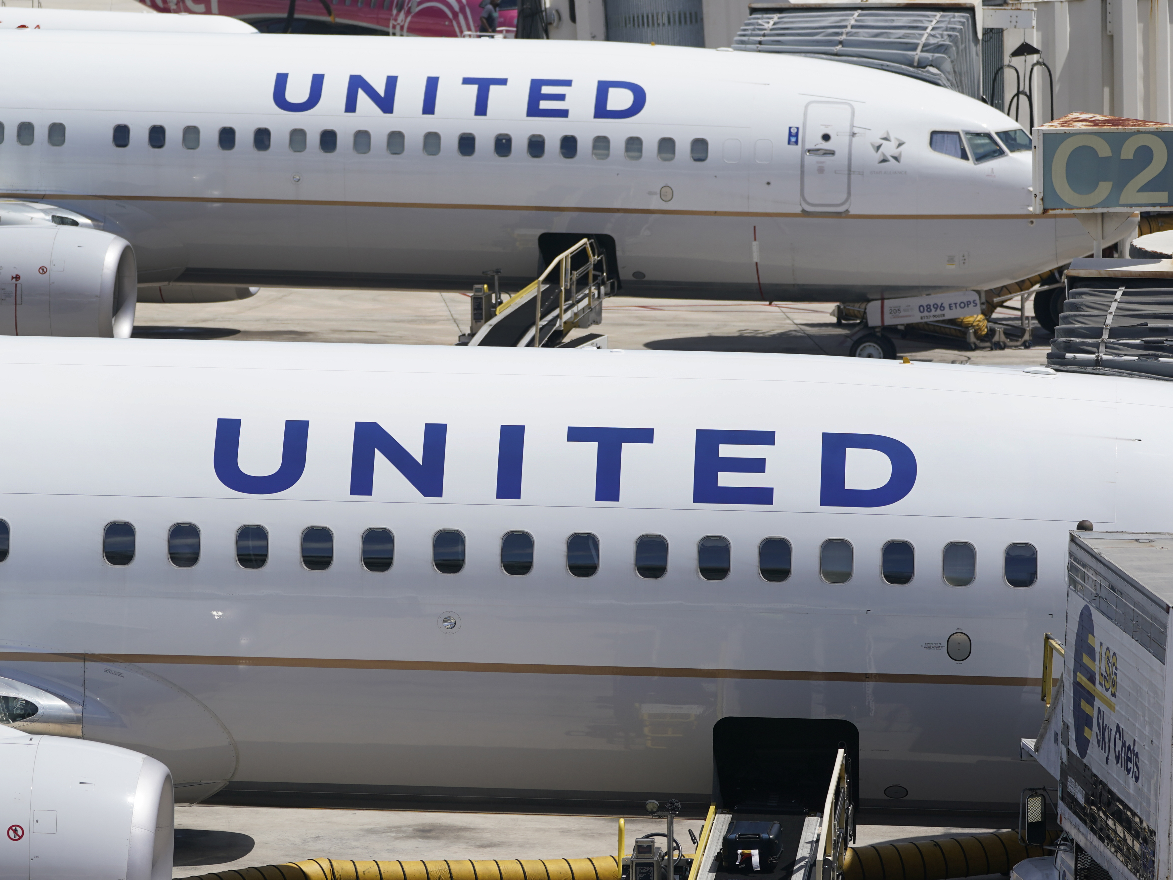 caption: Two United Airlines Boeing 737s are parked at the gate at the Fort Lauderdale-Hollywood International Airport in Fort Lauderdale, Fla., on July 7, 2022.