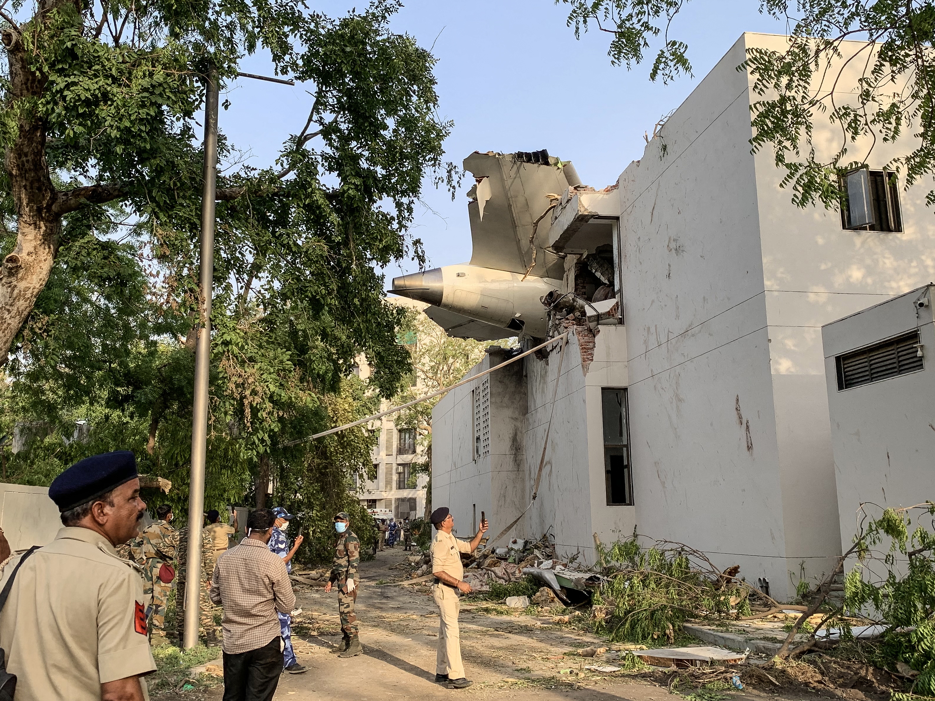 caption: The back of Air India Flight 171 juts out of a building after the Boeing 787-8 Dreamliner crashed in a residential area near the airport in Ahmedabad on Thursday.