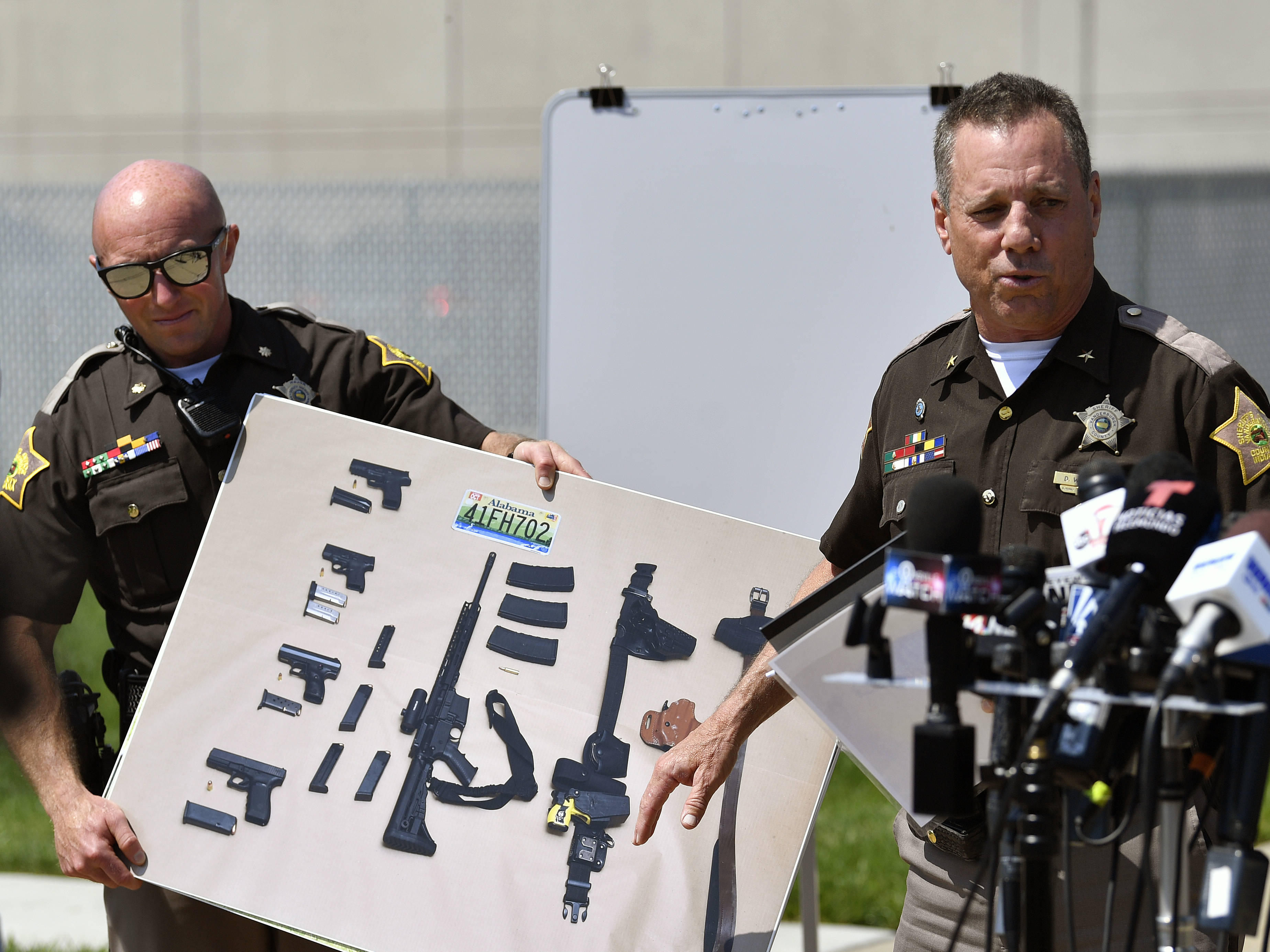 caption: During a news conference in Evansville, Ind., on Tuesday, Vanderburgh County Sheriff Dave Wedding shows a photograph of the weapons that were found in the possession of fugitives Casey White and Vicky White following their capture.