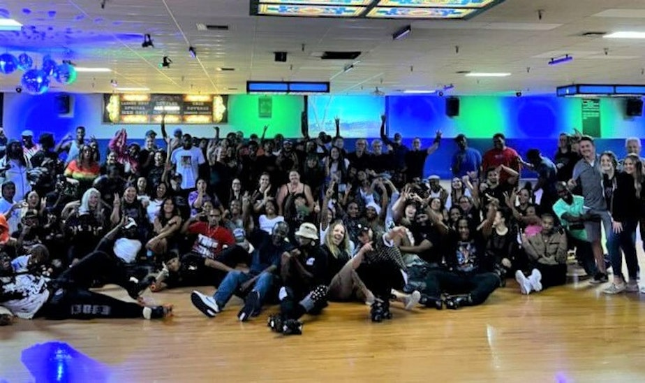 caption: Roller skaters pose for a photo after Pattison's West Skating Center's last adult night session under its previous ownership on Sunday, Oct. 2, 2022. The rink was recently purchased by the community nonprofit El Centro de la Raza, which plans to keep the rink open and make it part of a campus that will include a senior center and a park.