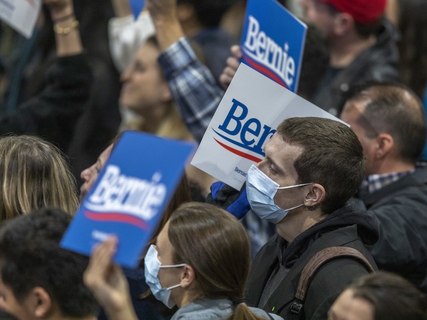 caption: Supporters wear medical masks, as fears of coronavirus increase in California, during a campaign rally for Presidential candidate Sen. Bernie Sanders in Los Angeles on March 1, 2020.