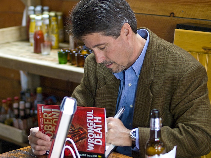 caption: Author Robert Dugoni at a book signing at the Tin Room Bar & Grill in Burien, Wash., in 2009.