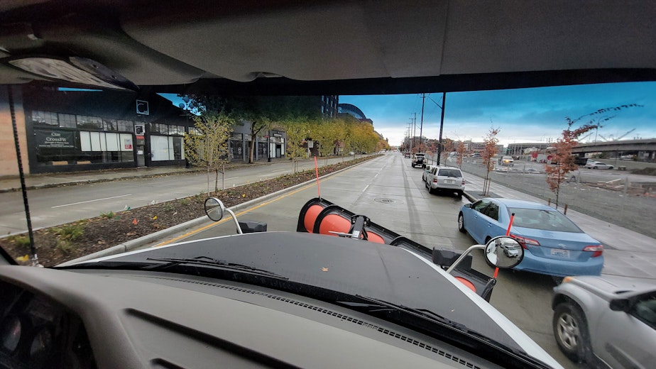 caption: A snow plow truck drives through Seattle's SoDo neighborhood on Tuesday, Nov. 7, 2023.