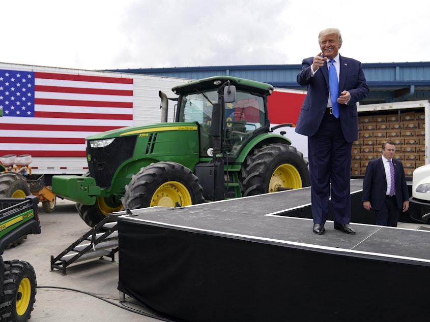 caption: President Trump delivered remarks on the Farmers to Families Food Box Program at Flavor First Growers and Packers last week in Mills River, N.C.