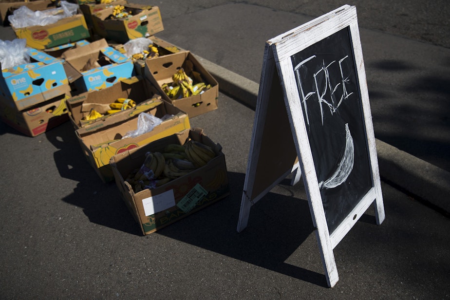 caption: Free food including bananas are boxed up at the entrance to the Tukwila Pantry Food Bank on Tuesday, September 22, 2020, on South 140th Street in Tukwila.