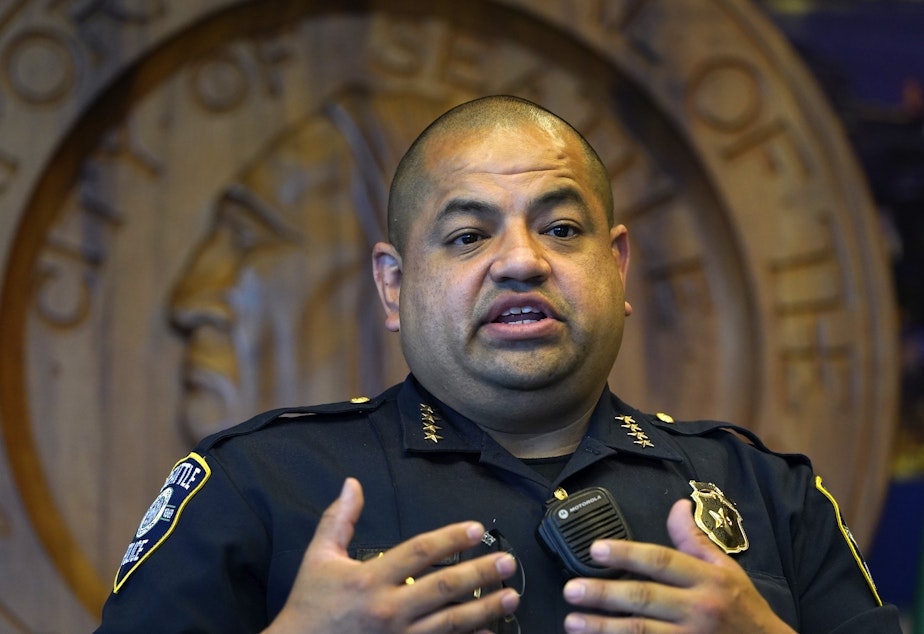caption: Interim Seattle Police Chief Adrian Diaz addresses a news conference about changes being made at the department, earlier this month. The SPD announced Thursday that an officer seen on video rolling his bicycle over a downed protester was suspended pending an investigation.