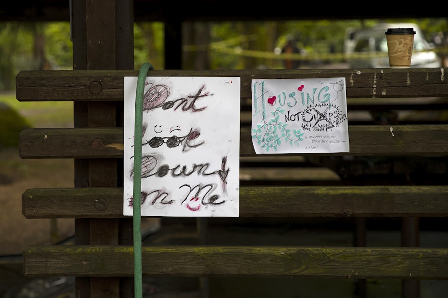 caption: 'Don't look down on me' reads a handwritten sign as the city of Seattle removed unhoused people and their belongings from an encampment on Tuesday, May 10, 2022, at Woodland Park in Seattle. 