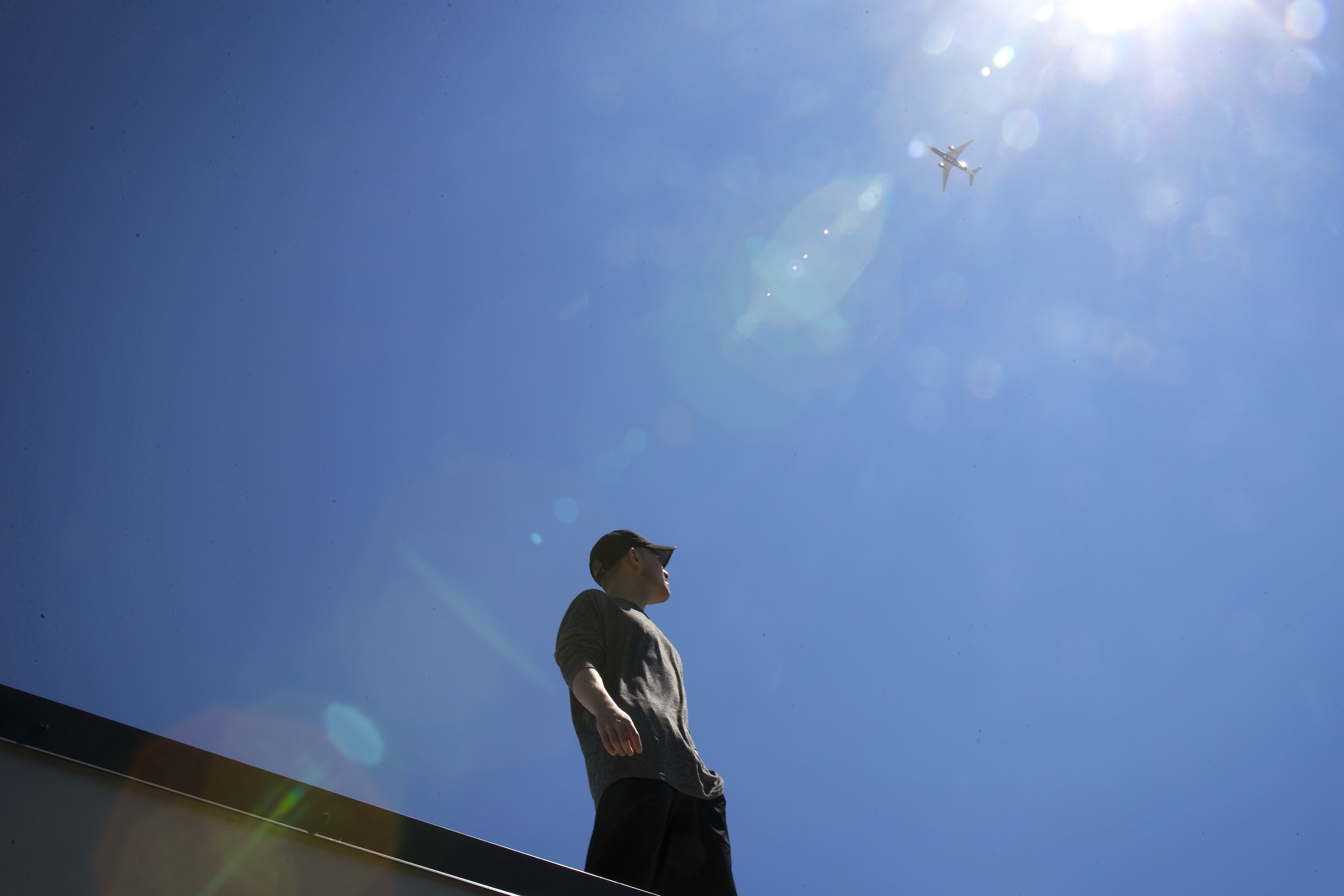 caption: Nikk Wong lives on North Beacon Hill and wonders if a plane might one day crash on his house.