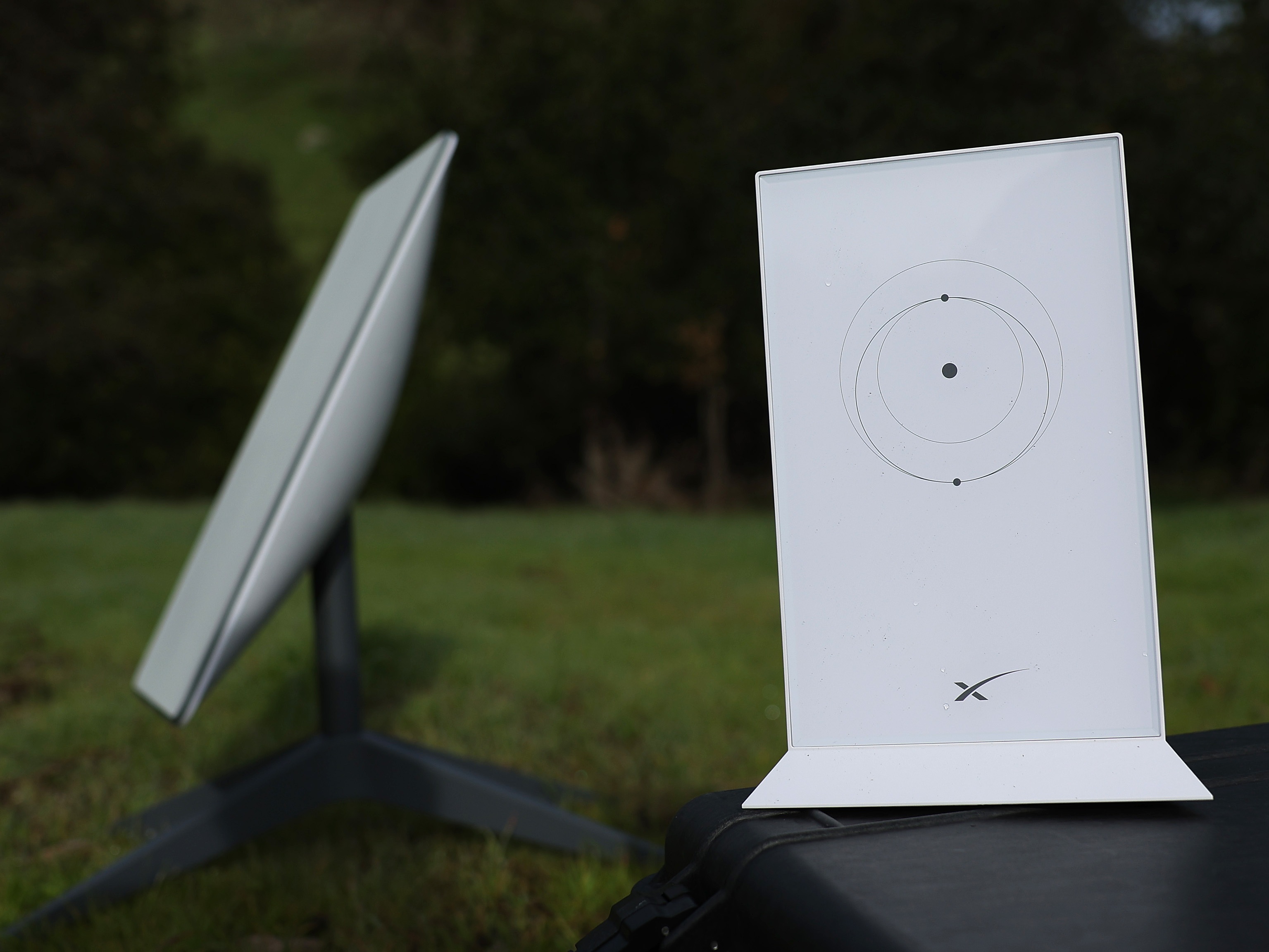 caption: In this photo illustration, a Starlink dish and router are displayed on February 12, 2024 in San Anselmo, California.