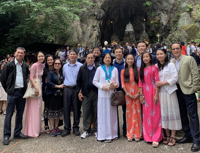 caption: Hong (second from left) and her extended family pose for their annual picture at the 2019 Freedom Mass at the Grotto in Portland, Oregon. The mass is organized by Portland's Vietnamese Catholic community.