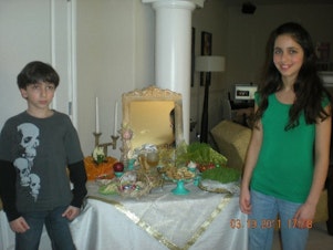 caption: Soraya Marashi (right) and her brother Cyrus, celebrating the Persian New Year. Soraya is wearing makeup because she's about to perform in her school musical presentation of Seussical.