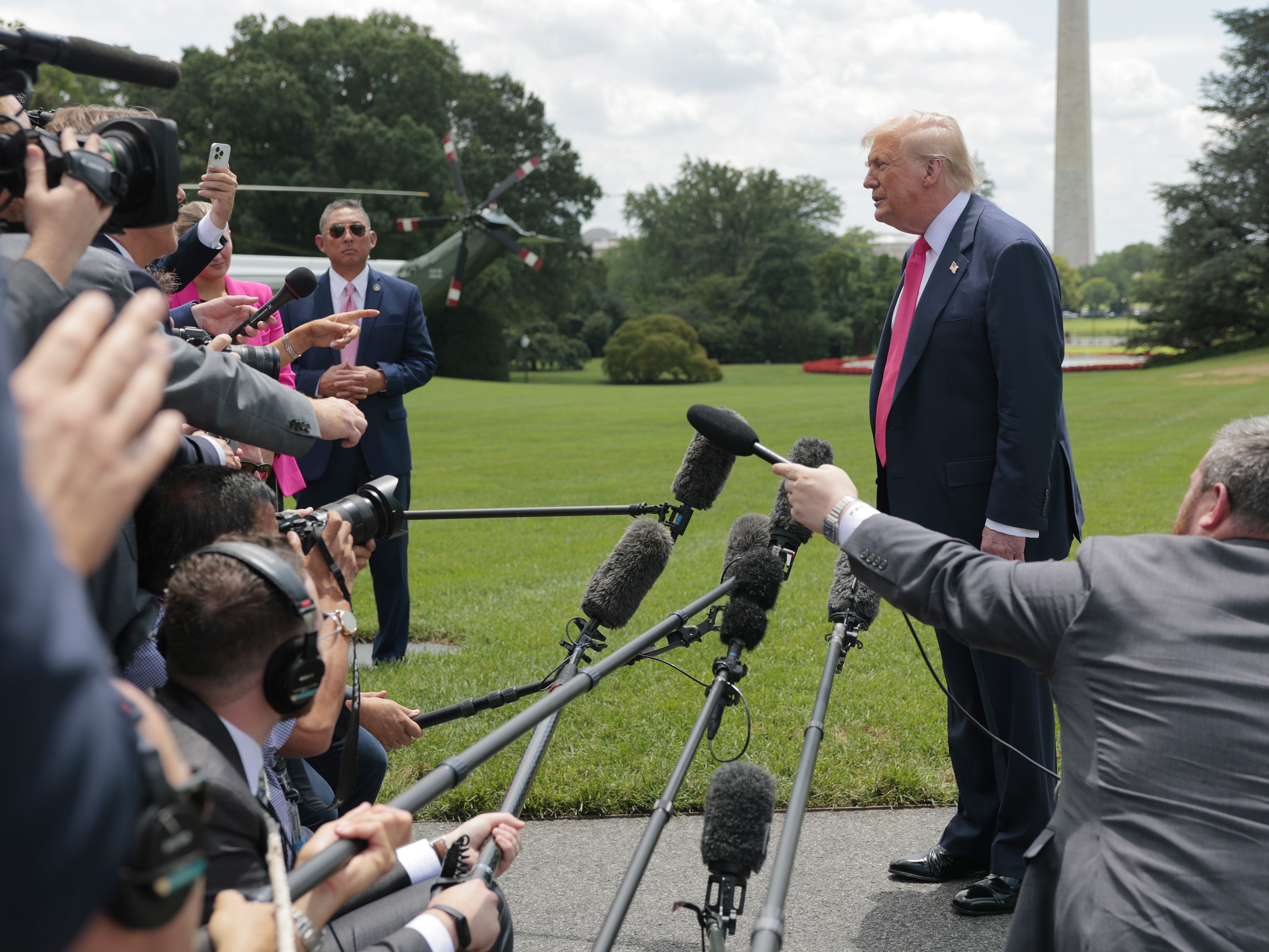 caption: President Trump speaks to the media as he departs the White House on July 15 for Pittsburgh.
