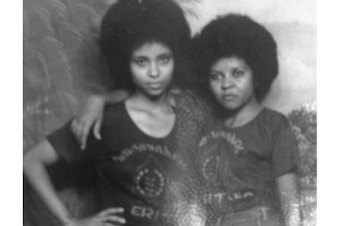 caption: Akberet Asfaha (right) poses with her best friend and fellow soldier, Amna Mohammad. Akberet left home at age 16 without her parents' permission to fight in the Eritrean War of Independence.