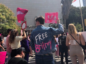 caption: Britney Spears supporter Peter Stickles was among those demonstrating outside Los Angeles Superior Court on Wednesday.