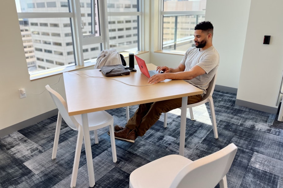 caption: Paul Schumann studies in the 17th floor common area of The Rise. That's the portion of the highrise reserved for people on modest incomes.