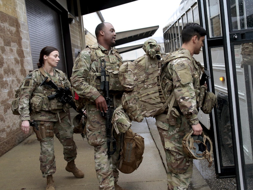 caption: U.S. Army soldiers board a bus in January 2020 at Fort Bragg, N.C., one of the military bases that will likely see population boosts in their 2020 census counts due to a change to how troops deployed abroad were counted.