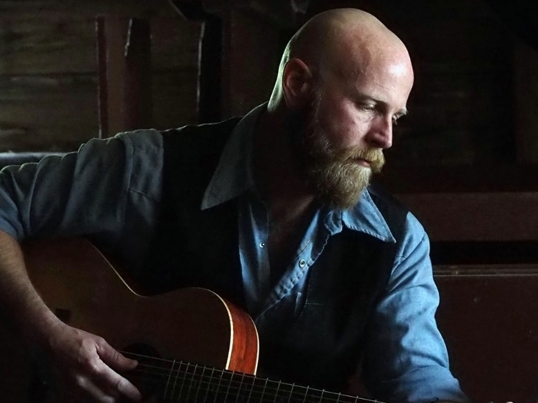 caption: Songwriter Dan Johnson released an album earlier this year and a companion book that focuses on the mental health struggles of many veterans. He founded a non-profit called Project Hemingway dedicated to bringing down the veteran suicide rate.