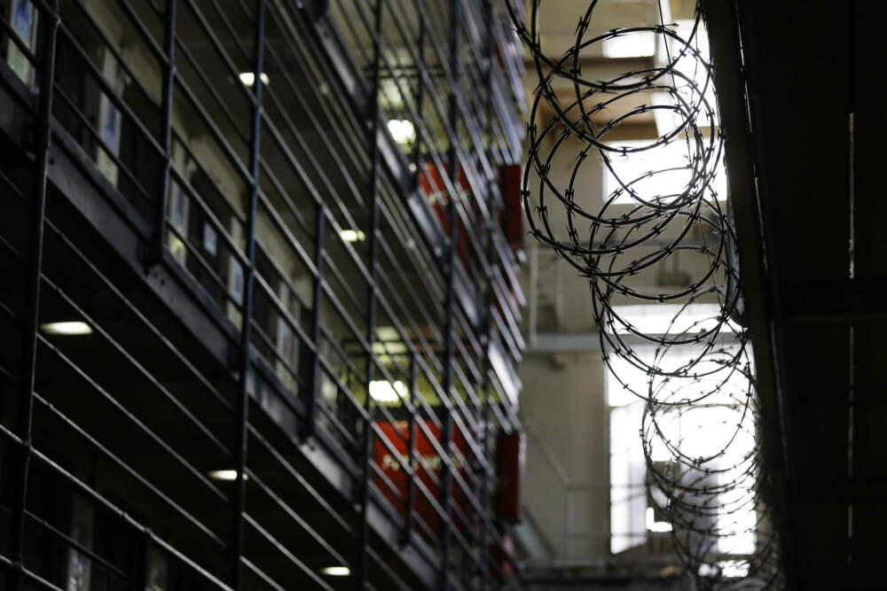 caption: FILE — Barbed wire is seen inside the east block of death row at San Quentin State Prison. (Eric Risberg/AP)