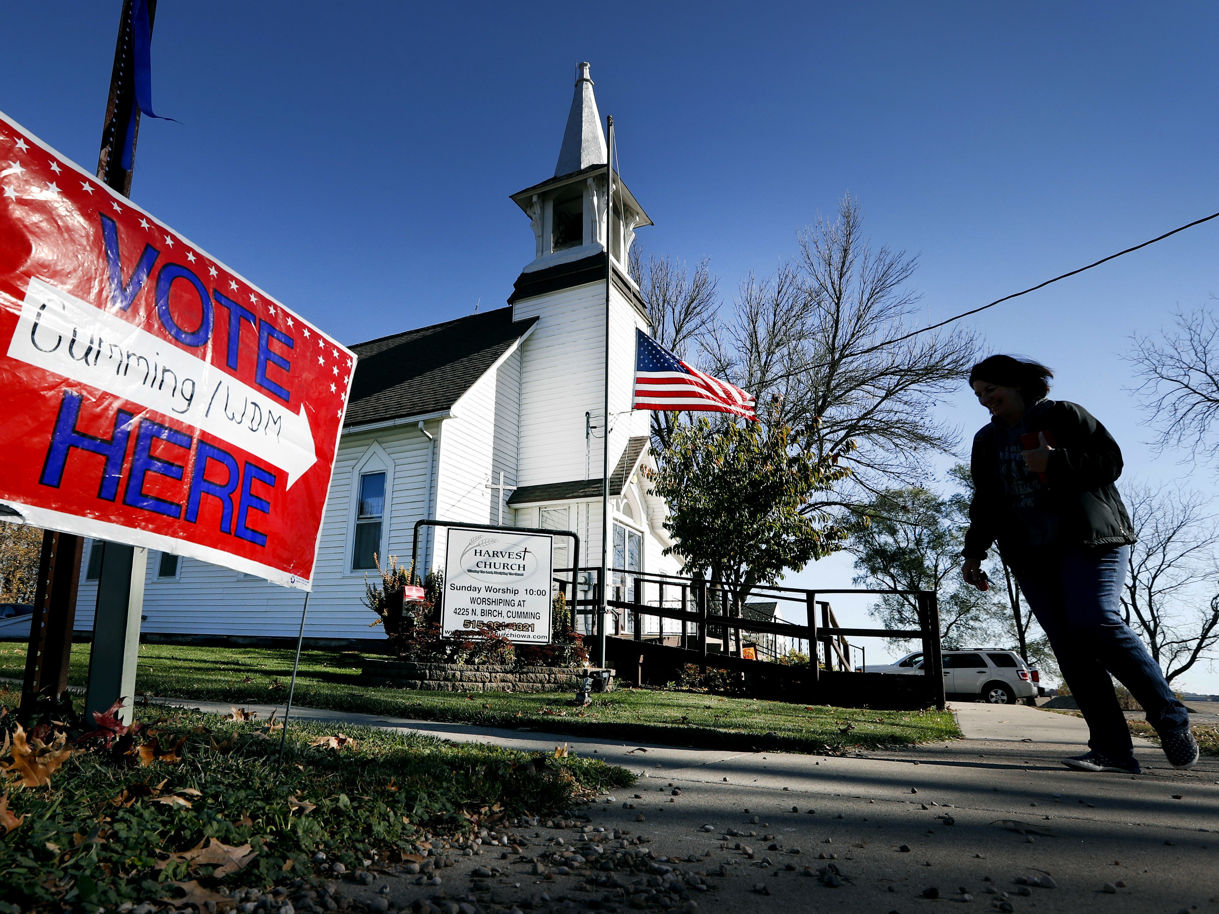 caption: A local resident leaves a church after voting in an election in Cumming, Iowa.