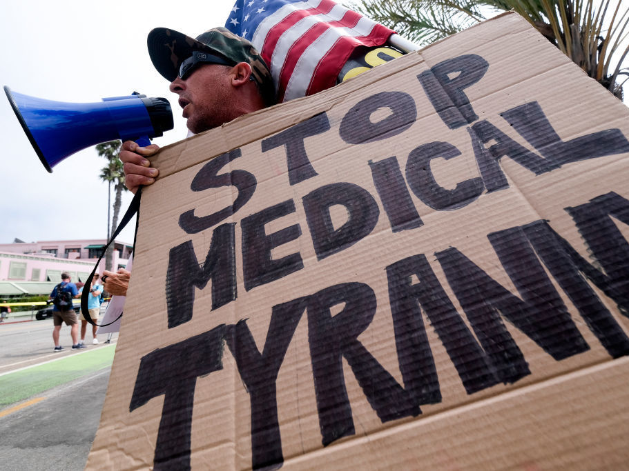 caption: People opposed to COVID-19 vaccines often embrace ivermectin, a drug that's been touted as an effective prevention and treatment for COVID-19, which they think is not getting the attention it deserves. Here, an anti-vaccination protester takes part in a rally against vaccine mandates, in Santa Monica, Calif.