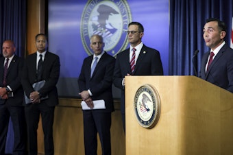 caption: U.S. Attorney Martin Estrada for the Central District of California, right, speaks during a press conference at the U.S. Attorney's Office for the Southern District of California on Thursday, Aug. 3, 2023, in San Diego.