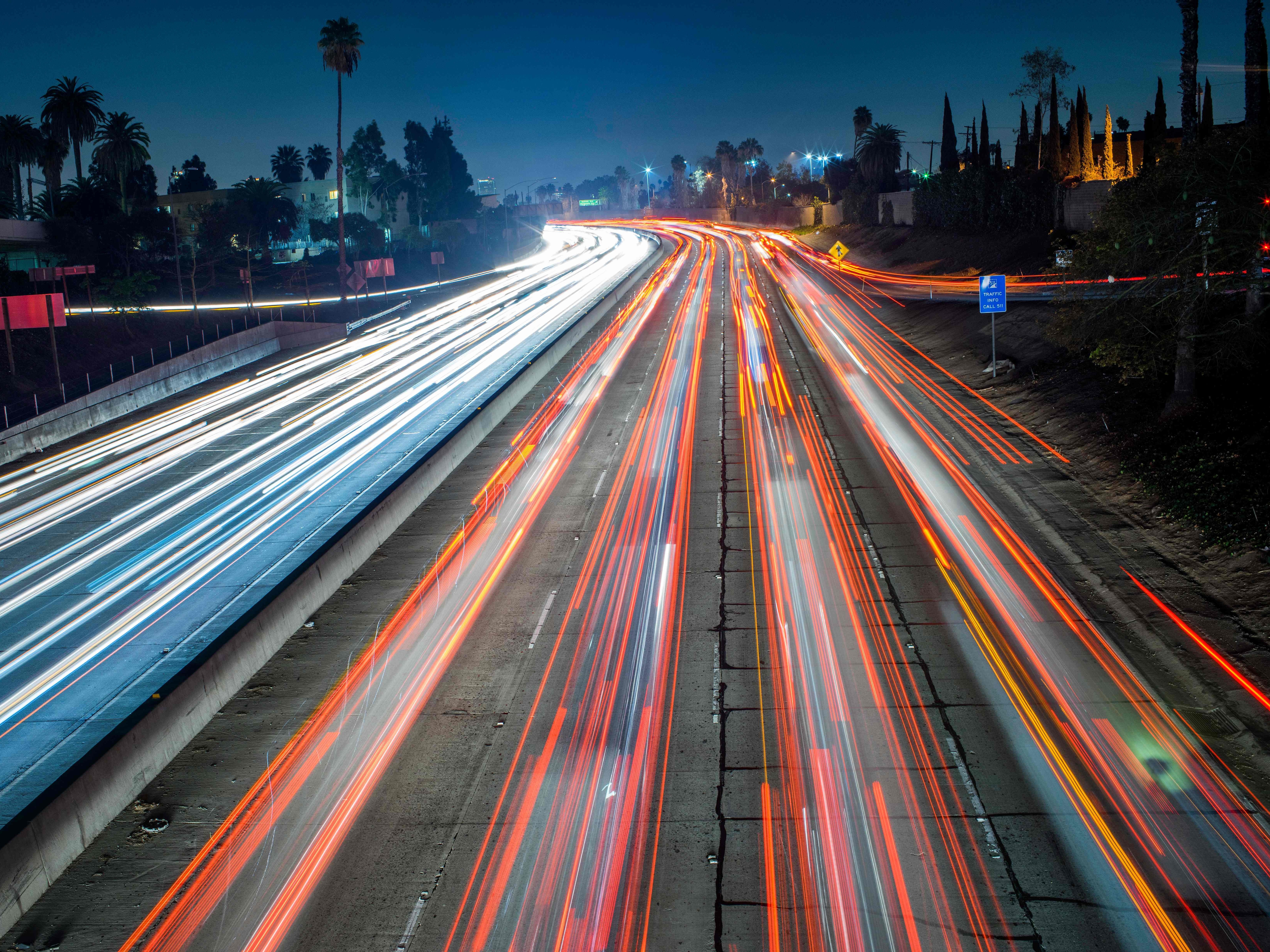 caption: Cars and trucks move slowly during evening rush hour on the Hollywood Freeway in Los Angeles, Calif. in 2014.