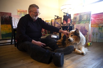 caption: Ned Beck pets his 12-year-old dog Bud at his apartment on Wednesday, February 28, 2024, in Auburn. 