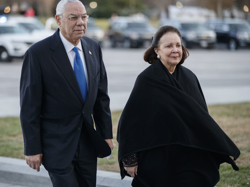 caption: Former Secretary of State Colin Powell, seen here in December 2018 with his wife, Alma, said he would vote for Joe Biden.