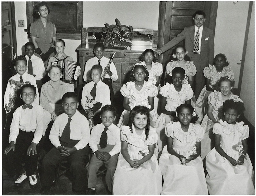 caption: Music teachers Shirley and Louis Wilcox with students at their music school. (To help us ID the children, note the photo number. This is #11.)