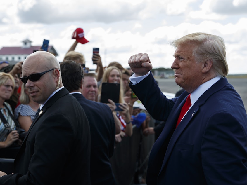 caption: President Trump greets supporters after arriving at Florida's Ocala International Airport on Thursday to give a speech on health care at The Villages retirement community.