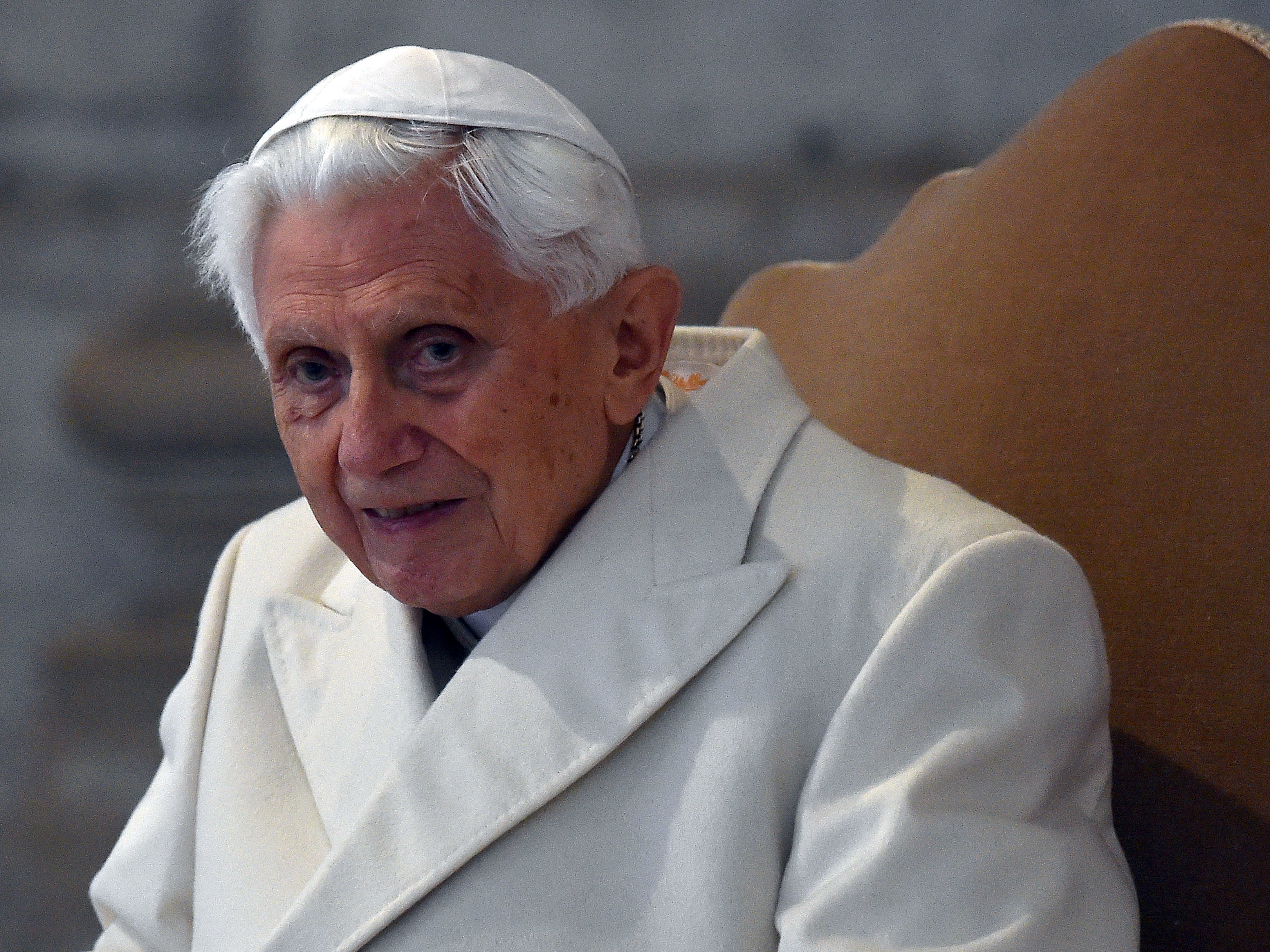 caption: Pope Emeritus Benedict XVI arrives at St Peter's basilica in 2015. Benedict has stayed largely silent on the church's sex abuse scandal for the past six years.