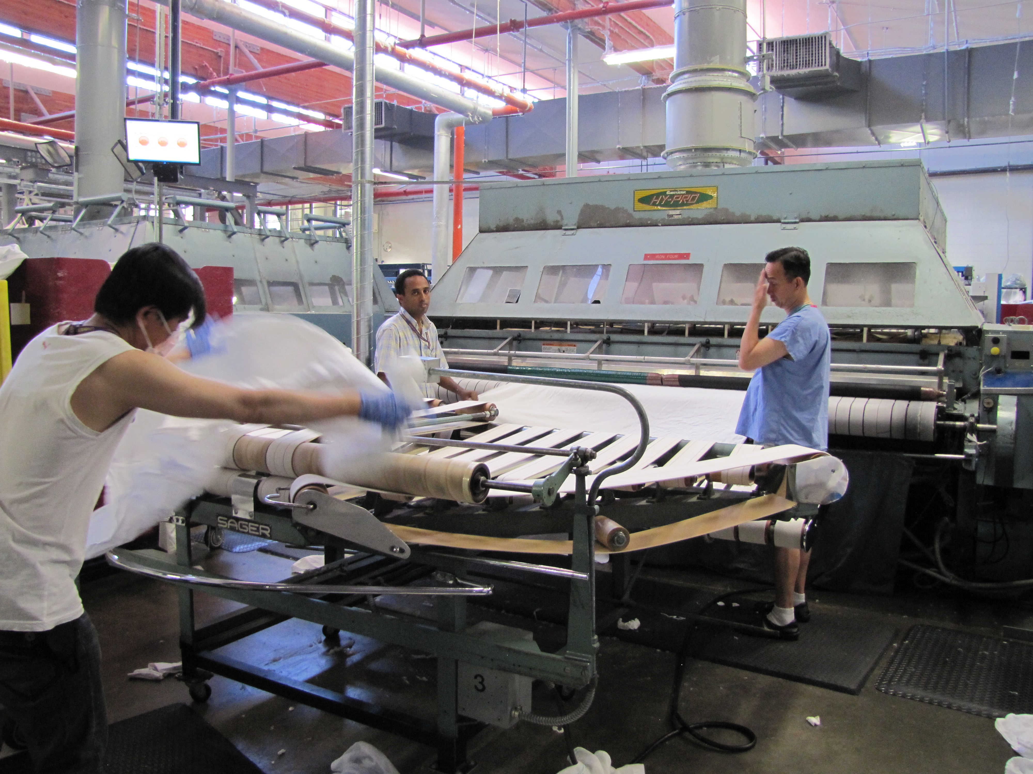 caption: Workers at UW's consolidated laundry facility.