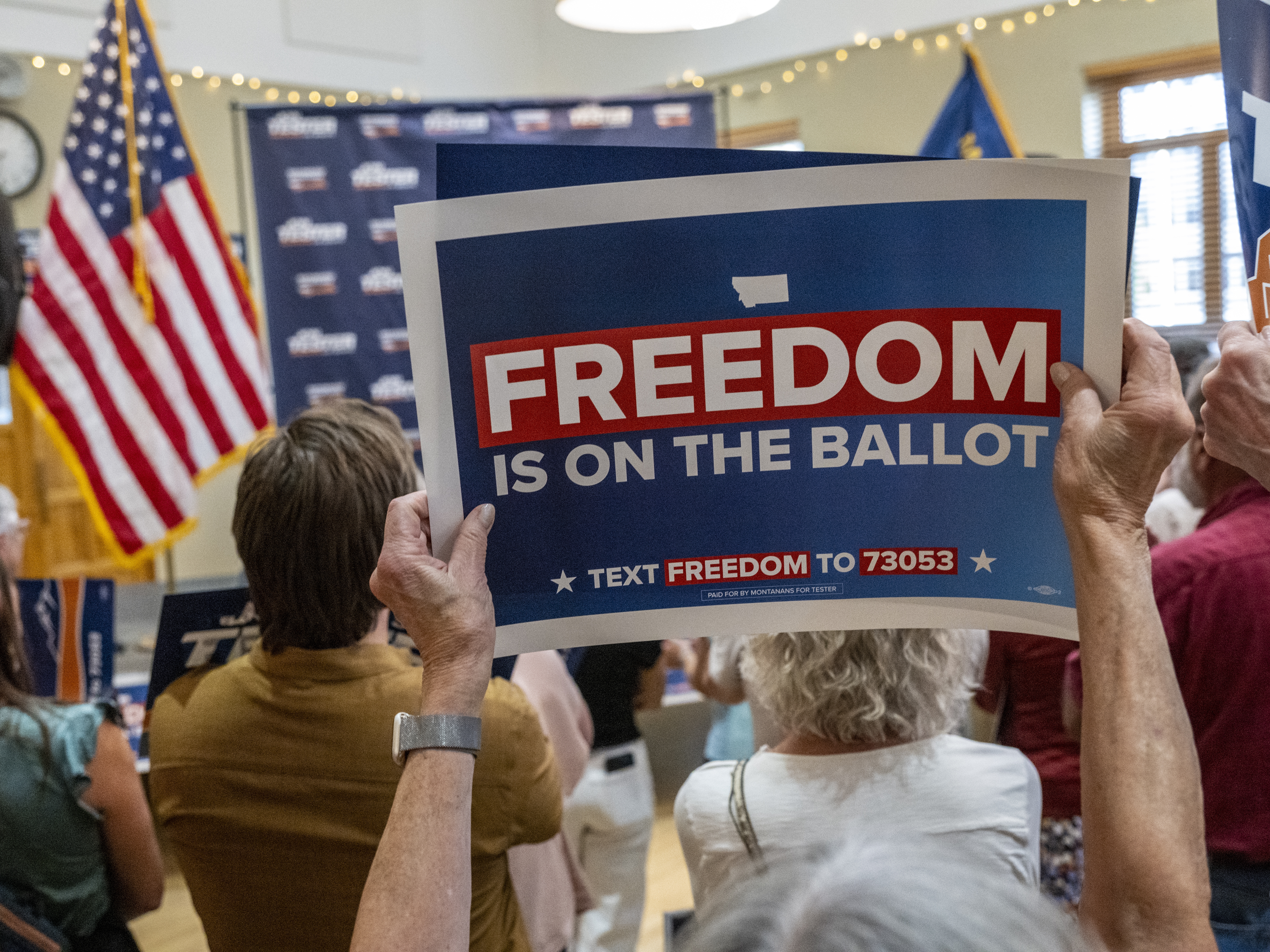 caption: Signs supporting the abortion rights amendment are displayed during a rally on September 5, 2024 in Bozeman, Mont.