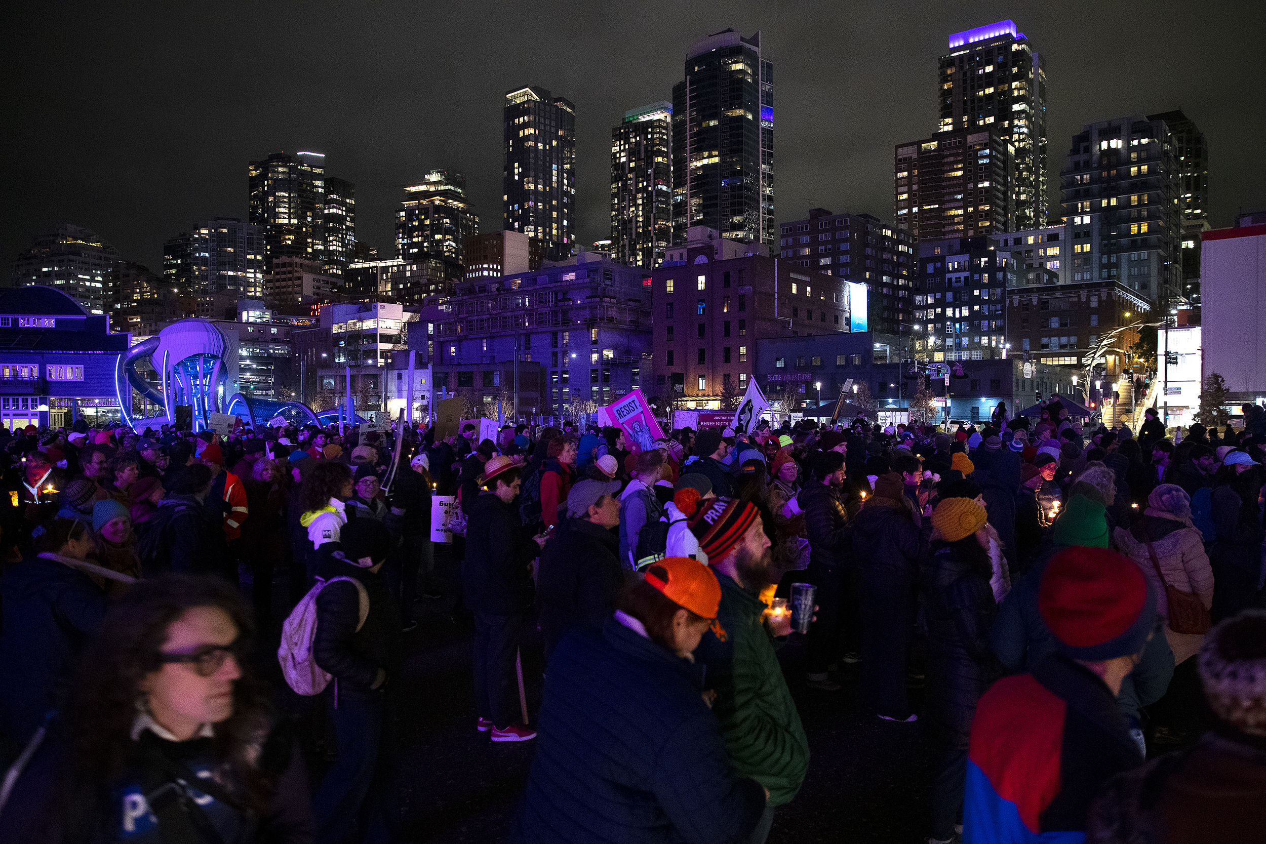 caption: Hundreds begin a march following a vigil in honor of Renee Nicole Good, the Minneapolis mother of three who was shot in the head and killed by an ICE agent earlier this week, on Thursday, January 8, 2026, at Pier 58 in Seattle. 