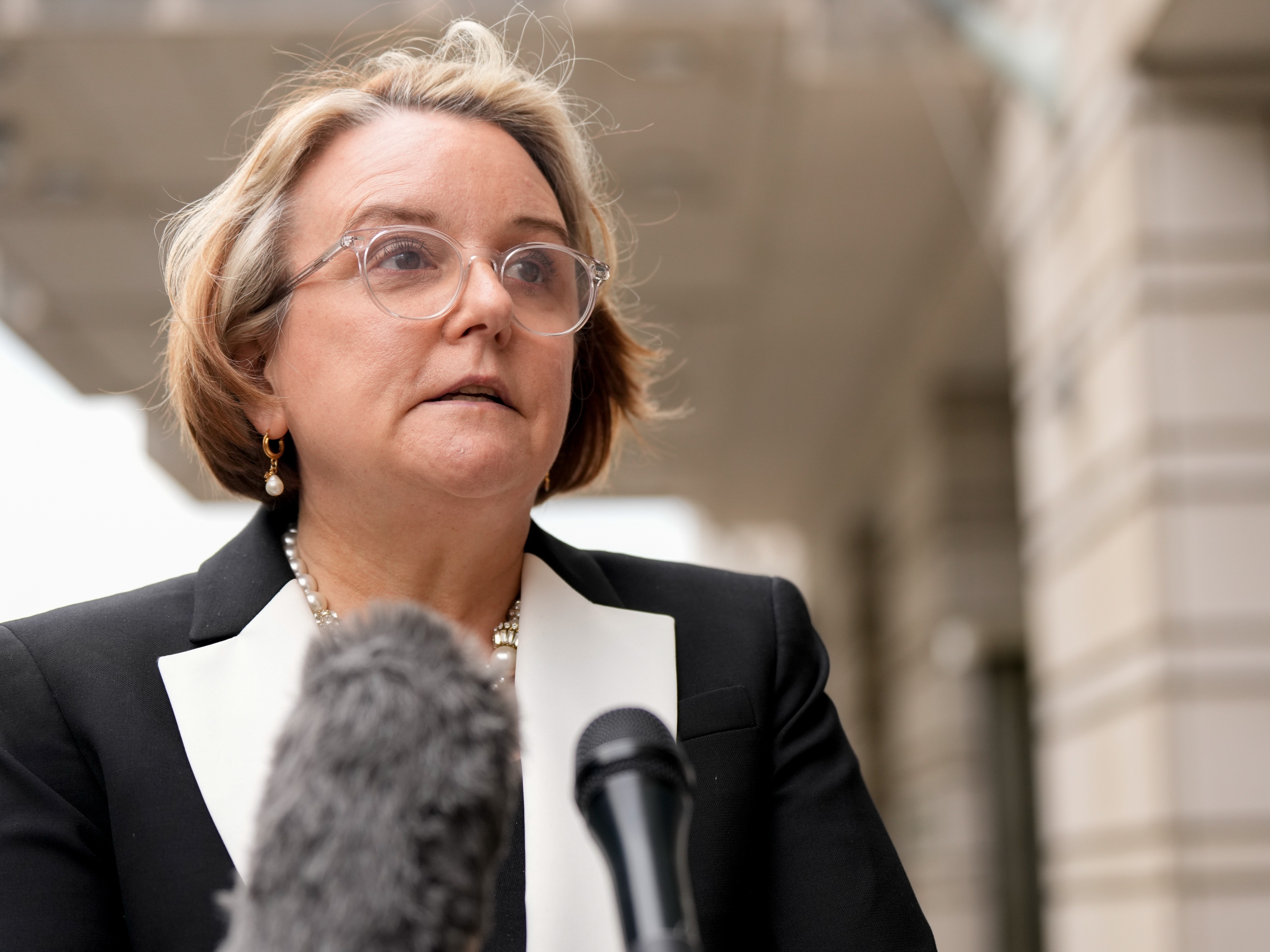 caption: Abigail Slater, US assistant attorney general for the Antitrust Division, speaks to members of the media outside federal court in Washington, DC, US, on Monday, April 21, 2025. Google will square off against the Justice Department and dozens of state attorneys general in a Washington court room over what changes the judge will order to prevent the company from monopolizing the online search market.