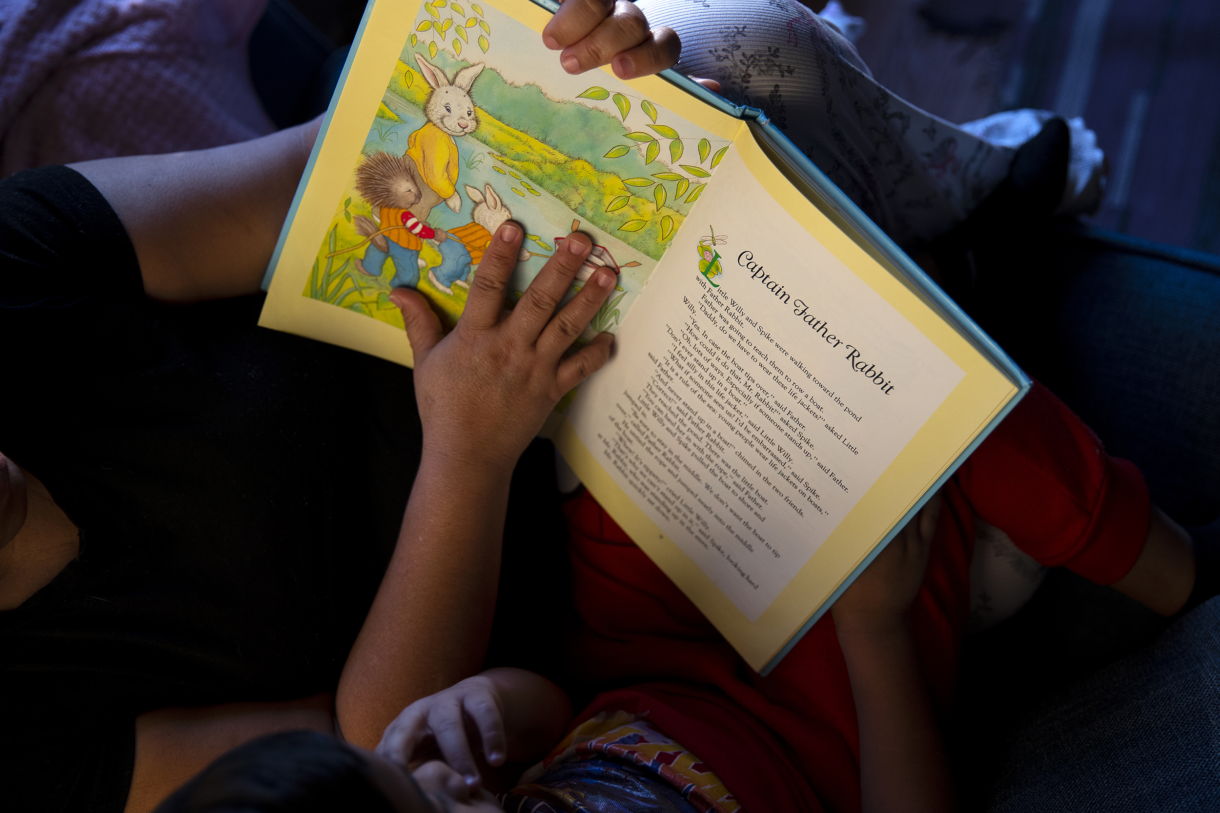 caption: Alejandra reads ‘Little Willy and Spike’ with her 6-year-old son after school on Friday, January 23, 2026, at Karina’s home in Seattle. 
