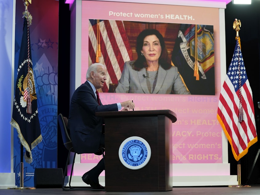 caption: President Joe Biden speaks as New York Gov. Kathy Hochul appears on a screen during a virtual meeting with Democratic governors on abortion rights on Friday.