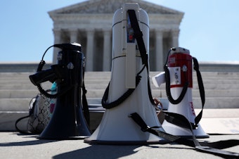 caption: Bullhorns are seen during a demonstration in front of the Supreme Court on June 29. The court had a momentous term with cases ranging from President Trump's financial records to immigration and abortion.