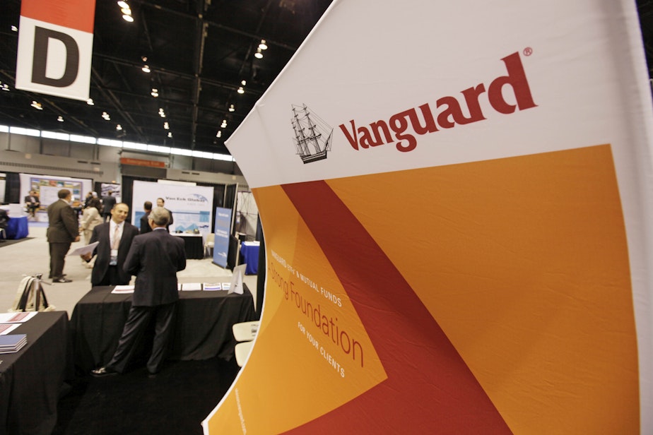 caption: An attendee of the 2010 Morningstar Investment Conference speaks with Dave Varrelman, right, a sales associate with Vanguard at the McCormick Center, Thursday, June 24, 2010, in Chicago. (AP Photo/M. Spencer Green)