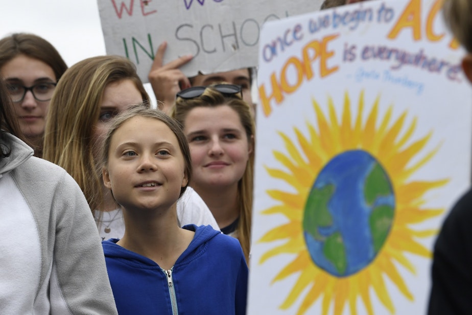 caption: Swedish youth climate activist Greta Thunberg, center, marches with other young climate activists for a climate strike outside the White House in Washington, Friday, Sept. 13, 2019.