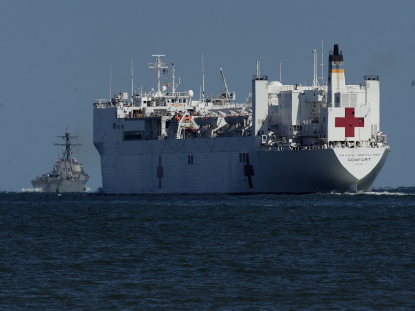 caption: USNS Comfort, seen in 2017, is one of two U.S. Navy hospital ships — along with the USNS Mercy — that are preparing to deploy to assist medical workers expecting to grapple with an influx of patients in the weeks to come.