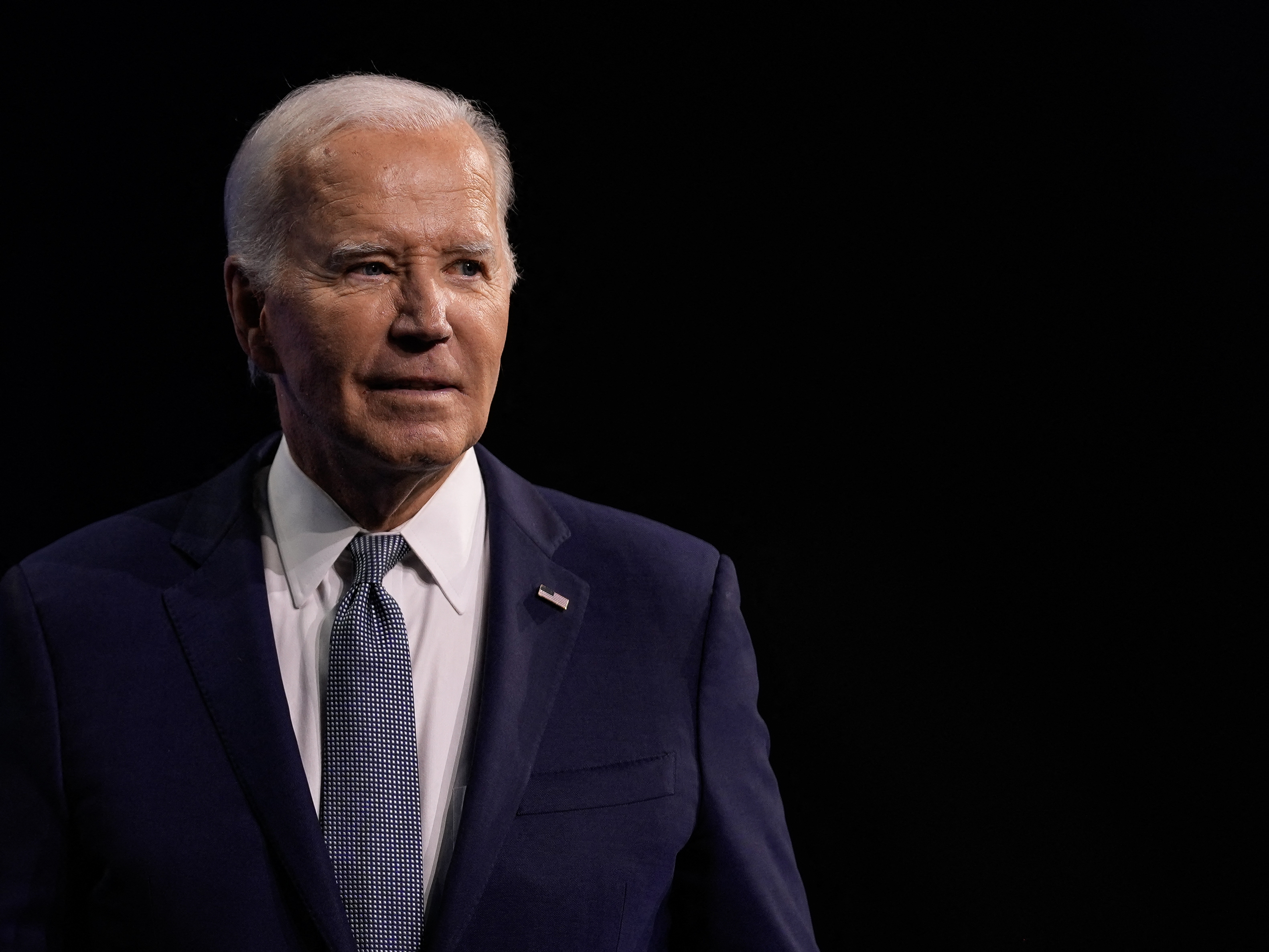caption: President Biden leaves the podium after speaking July 16 during the 115th NAACP National Convention in Las Vegas.