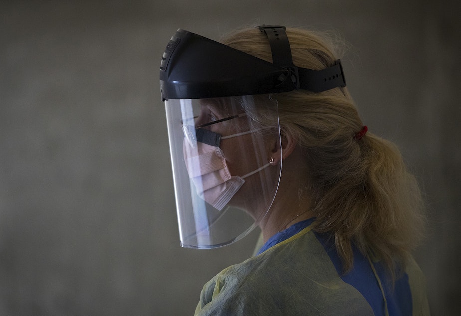 caption: Julie Czartoski, a nurse practitioner at Fred Hutch, waits for first responders to arrive to participate in the Seattle Covid Cohort Study on Wednesday, April 29, 2020, at Fred Hutch in Seattle. First responders with the Seattle Fire Department who either hadn't tested positive for the coronavirus, or had never been tested at all, were tested for the virus as well as for antibodies.