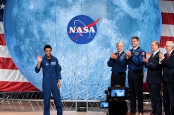 caption: NASA astronaut Jessica Watkins waves at the audience during the astronaut graduation ceremony at Johnson Space Center in Houston, Texas, in January 2020. In April 2022, she will become the first Black woman to live and work on the International Space Station.