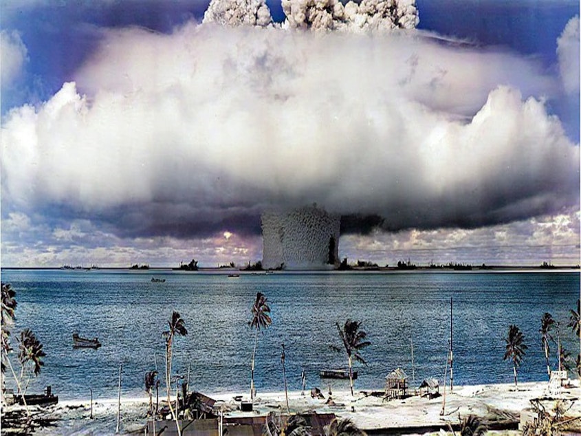 caption: The Baker explosion, one of many nuclear bombs the US detonated at the Marshall Islands.